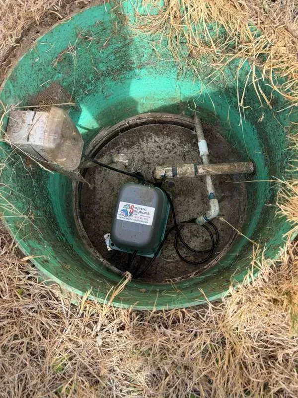 The pump tank opened up, with the air pump and its pipework.