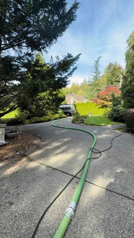 The suction hose run up the driveway to the vacuum truck at the top of the property.