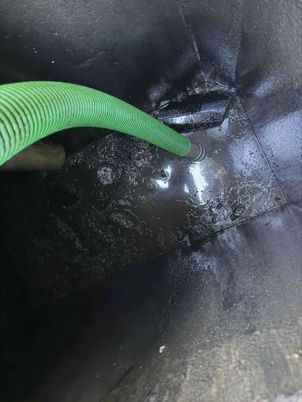 Inside the tank during pumping, with the suction hose in place.