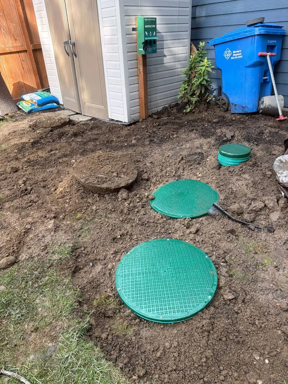 The finished installation, with the new lids sitting flush in the ground.