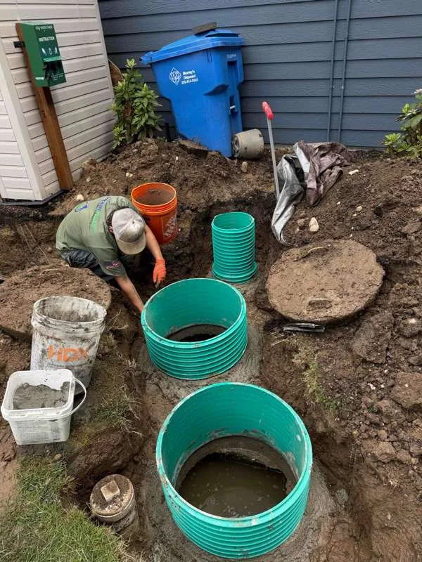 Our technician setting the risers, with concrete mixed and ready in the buckets alongside.