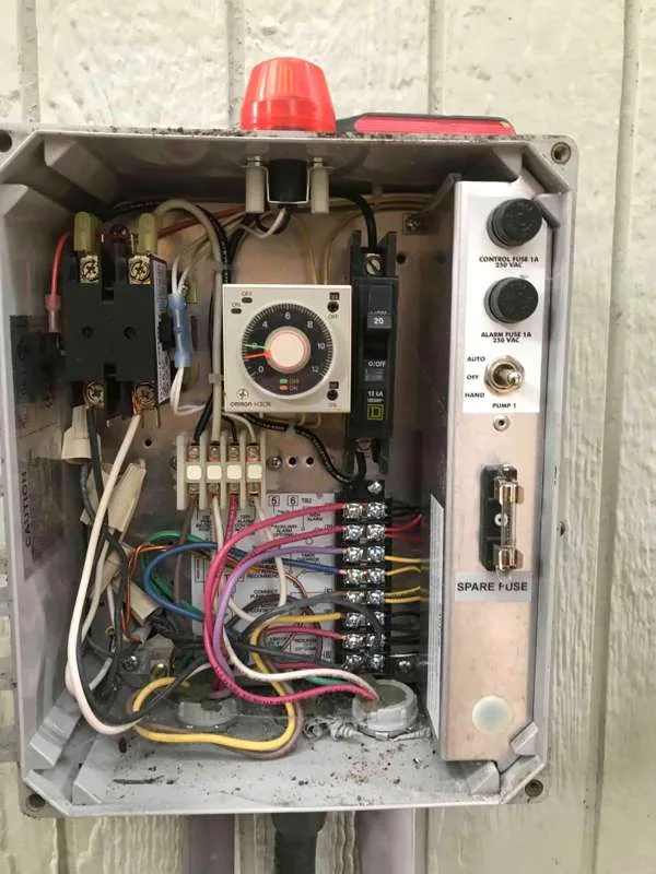 The control panel opened up, showing the timer, the breaker and the control and alarm fuses.