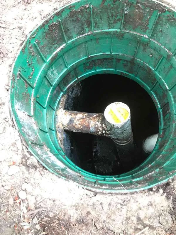 Inside the riser after the hose came out, the capped pipe standing above the emptied tank.