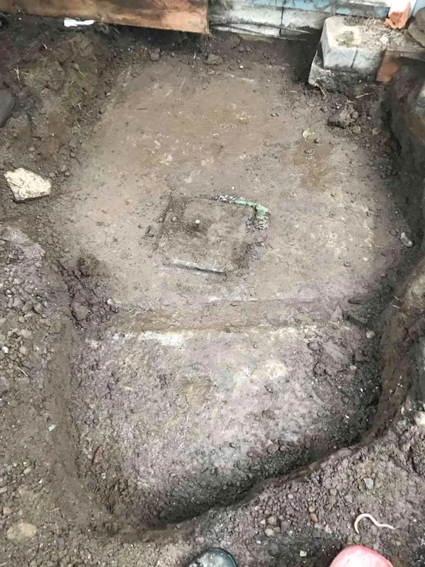 The top of the tank cleared, with a small square access opening cut into it.