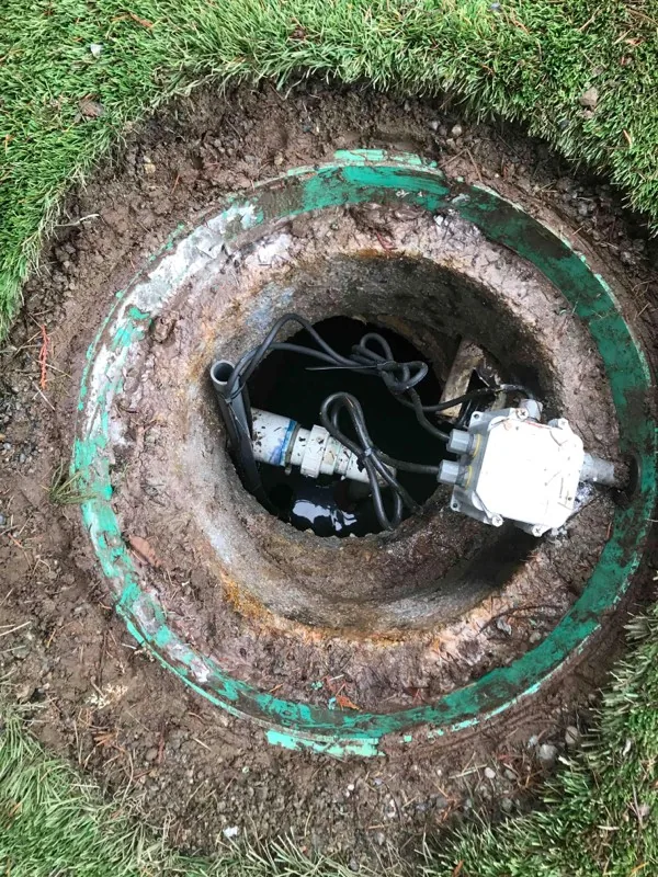 Looking down a riser at the junction box and cabling inside it.