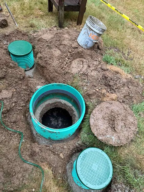 A new riser seated over the tank opening, sealed down onto the lid below.