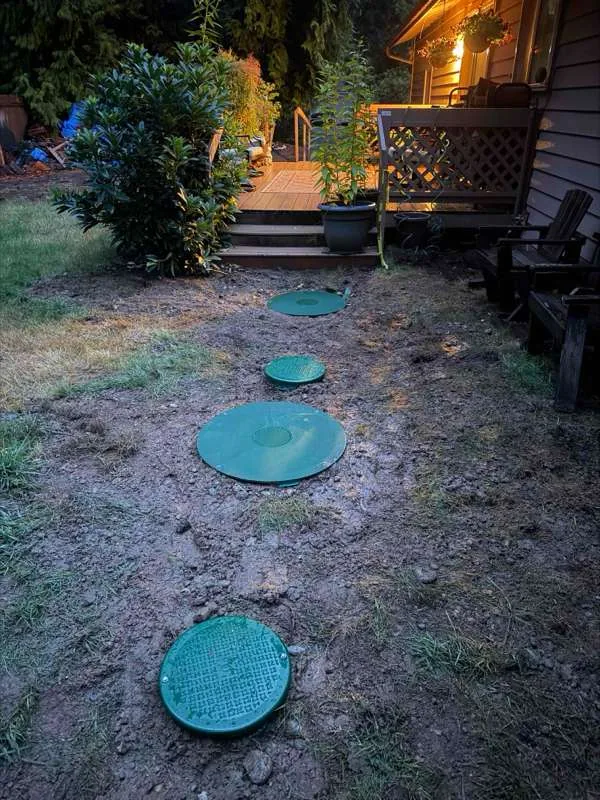 The finished run of lids at ground level across the garden at the end of the day.