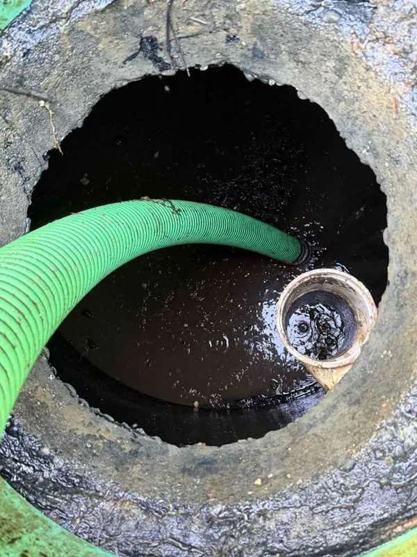 The suction hose run down into the tank beside the outlet pipe.