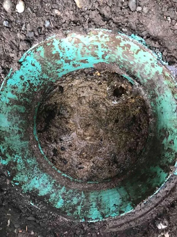 Looking down a riser at a lid caked in solids.